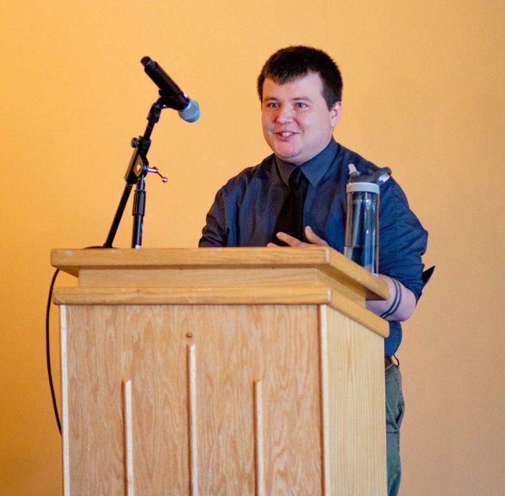 Kyle Inselman speaking at DU's Lavender Graduation, 2018